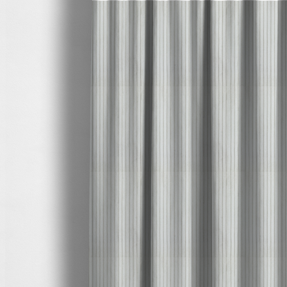 The fabric used to create these made-to-measure curtains is a light grey corduroy featuring a consistent vertical ribbed texture.