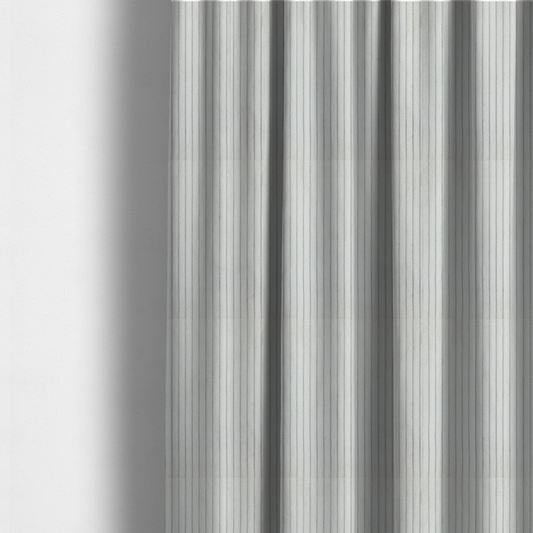 The fabric used to create these made-to-measure curtains is a light grey corduroy featuring a consistent vertical ribbed texture.