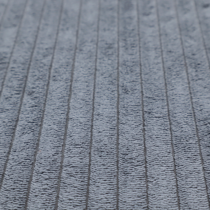 This fabric is a medium-to-dark grey corduroy featuring a consistent vertical ribbed texture.