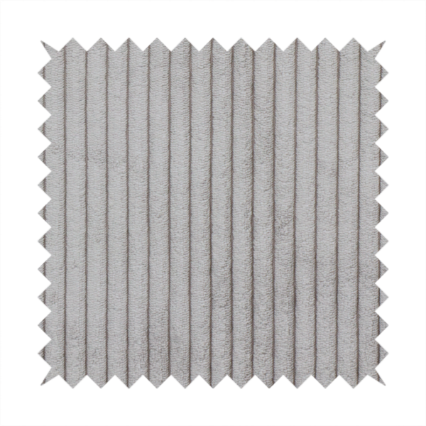 This fabric is a cool-toned, light grey or silver-grey corduroy featuring a consistent vertical ribbed texture.