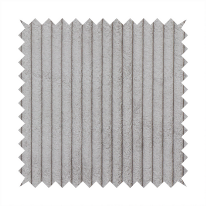 This fabric is a cool-toned, light grey or silver-grey corduroy featuring a consistent vertical ribbed texture.