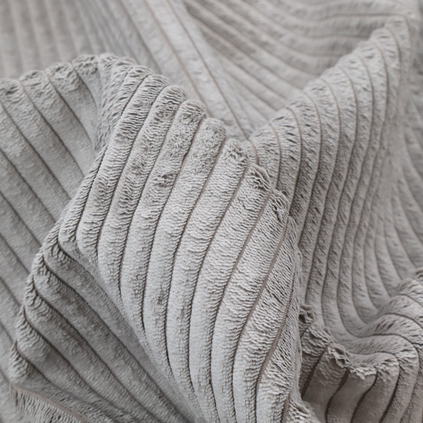 This fabric is a cool-toned, light grey or silver-grey corduroy featuring a consistent vertical ribbed texture.