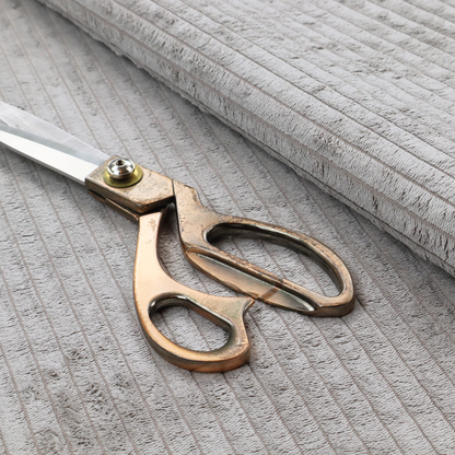 This fabric is a cool-toned, light grey or silver-grey corduroy featuring a consistent vertical ribbed texture.