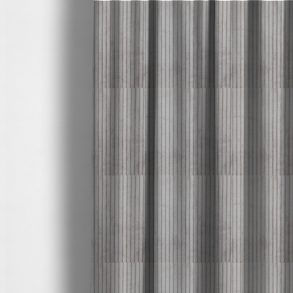 The fabric used to create these made-to-measure curtains is a cool-toned, light grey or silver-grey corduroy featuring a consistent vertical ribbed texture.