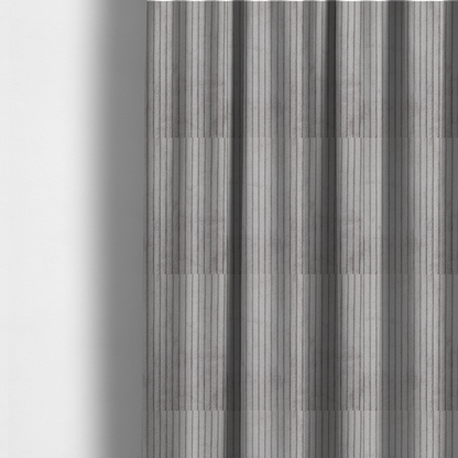 The fabric used to create these made-to-measure curtains is a cool-toned, light grey or silver-grey corduroy featuring a consistent vertical ribbed texture.