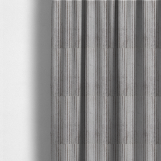 The fabric used to create these made-to-measure curtains is a cool-toned, light grey or silver-grey corduroy featuring a consistent vertical ribbed texture.