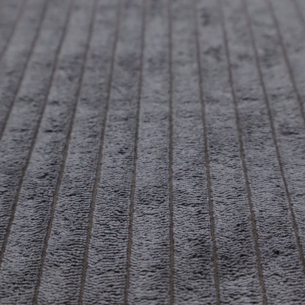 This fabric is a dark, cool-toned charcoal or slate-grey corduroy featuring a consistent vertical ribbed texture.