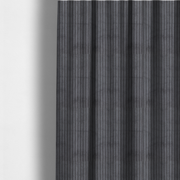 The fabric used to create these made-to-measure curtains is a dark, cool-toned charcoal or slate-grey corduroy featuring a consistent vertical ribbed texture.