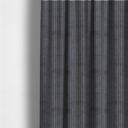 The fabric used to create these made-to-measure curtains is a dark, cool-toned charcoal or slate-grey corduroy featuring a consistent vertical ribbed texture.