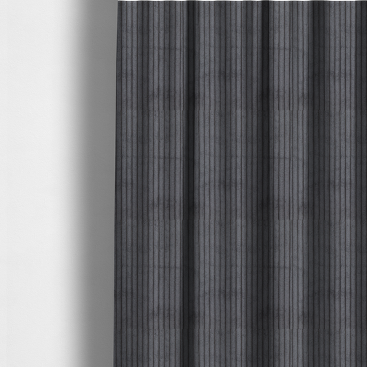 The fabric used to create these made-to-measure curtains is a dark, cool-toned charcoal or slate-grey corduroy featuring a consistent vertical ribbed texture.