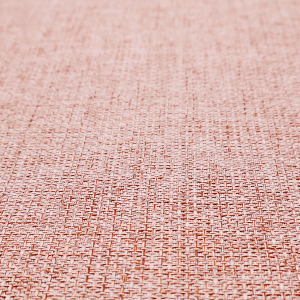 A tightly woven fabric in a dusty rose or muted terracotta colour, featuring a textured basket-weave pattern.