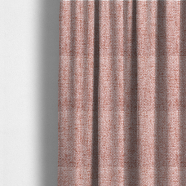 The fabric used to create these made-to-measure curtains is a tightly woven fabric in a dusty rose or muted terracotta colour, featuring a textured basket-weave pattern.