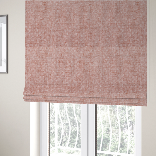 The fabric used to create these Roman blinds is a tightly woven fabric in a dusty rose or muted terracotta colour, featuring a textured basket-weave pattern.