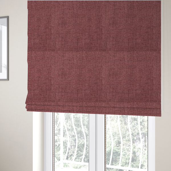 The fabric used to create these Roman blinds is a tightly woven fabric in a deep, muted berry or dusky plum shade, featuring a distinct, structured basket-weave pattern.