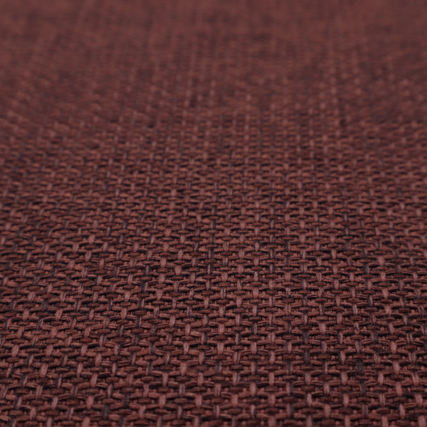 A tightly woven fabric in a deep, rich burgundy or dark maroon shade, featuring a distinct, structured basket-weave pattern.