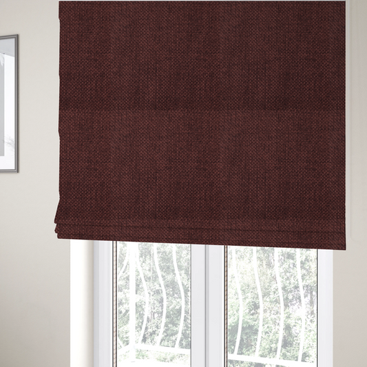 The fabric used to create these Roman blinds is a tightly woven fabric in a deep, rich burgundy or dark maroon shade, featuring a distinct, structured basket-weave pattern.