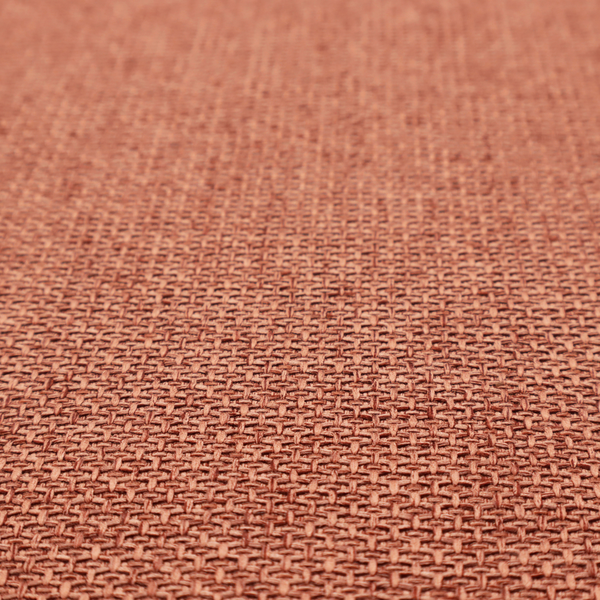 A tightly woven fabric in a warm, muted copper or terracotta shade, featuring a distinct, structured basket-weave pattern.