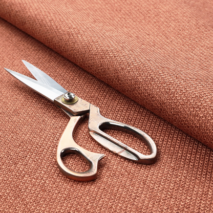 A tightly woven fabric in a warm, muted copper or terracotta shade, featuring a distinct, structured basket-weave pattern.