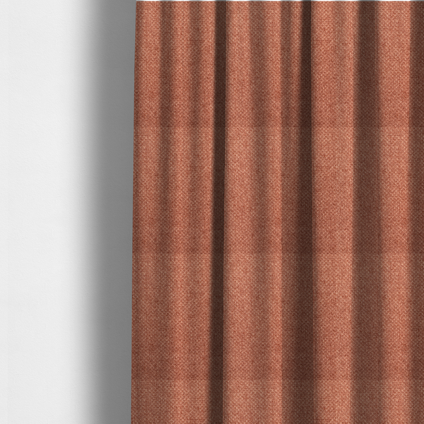 The fabric used to create these made-to-measure curtains is a tightly woven fabric in a warm, muted copper or terracotta shade, featuring a distinct, structured basket-weave pattern.