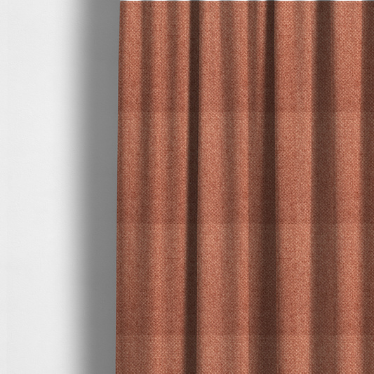 The fabric used to create these made-to-measure curtains is a tightly woven fabric in a warm, muted copper or terracotta shade, featuring a distinct, structured basket-weave pattern.