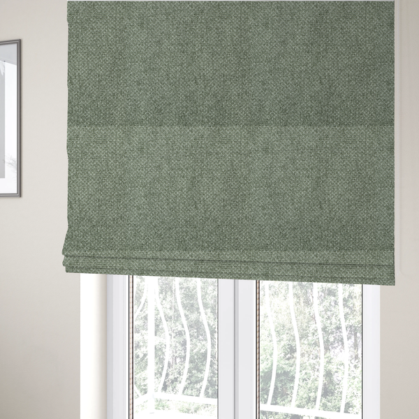 The fabric used to create these Roman blinds is a tightly woven fabric in a muted, earthy sage green shade, featuring a distinct, structured basket-weave pattern.