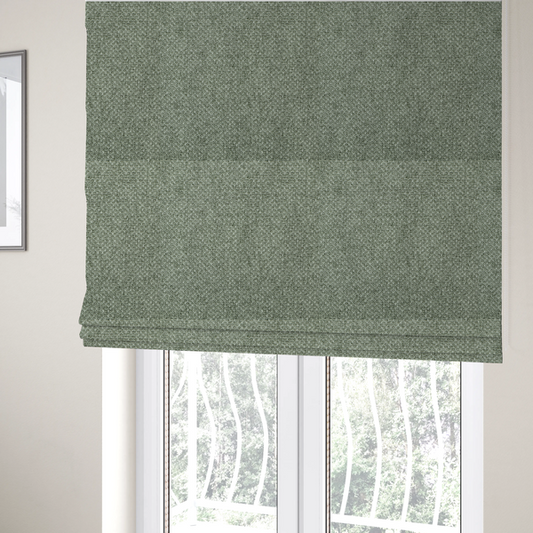 The fabric used to create these Roman blinds is a tightly woven fabric in a muted, earthy sage green shade, featuring a distinct, structured basket-weave pattern.