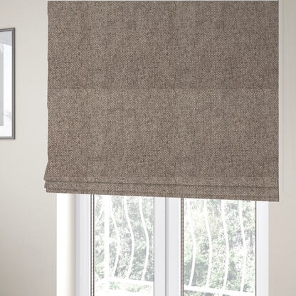 The fabric used to create these Roman blinds is a tightly woven fabric in a neutral, multi-tonal taupe and beige blend, featuring a distinct, structured basket-weave pattern