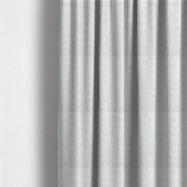 The fabric used to create these made-to-measure curtains is a tightly woven fabric in a clean, crisp off-white or light cream shade, featuring a distinct, structured basket-weave pattern.