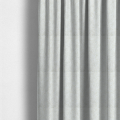 The fabric used to create these made-to-measure curtains is a tightly woven fabric in a clean, crisp off-white or light cream shade, featuring a distinct, structured basket-weave pattern.