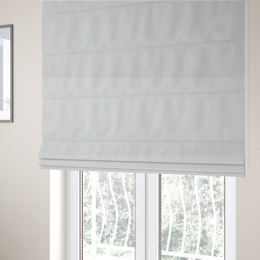 The fabric used to create these Roman blinds is a tightly woven fabric in a clean, crisp off-white or light cream shade, featuring a distinct, structured basket-weave pattern.
