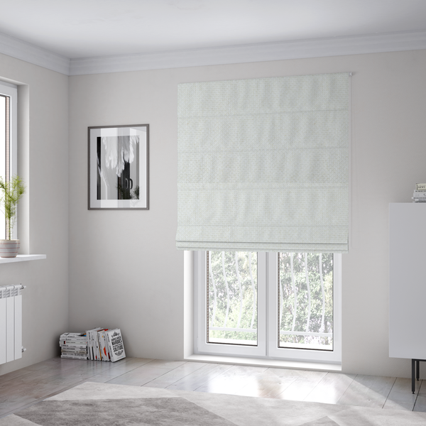 The fabric used to create these Roman blinds is a tightly woven fabric in a clean, crisp off-white or light cream shade, featuring a distinct, structured basket-weave pattern.