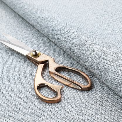 A tightly woven fabric in a soft, cool-toned sky blue and white blend, featuring a distinct, structured basket-weave pattern.