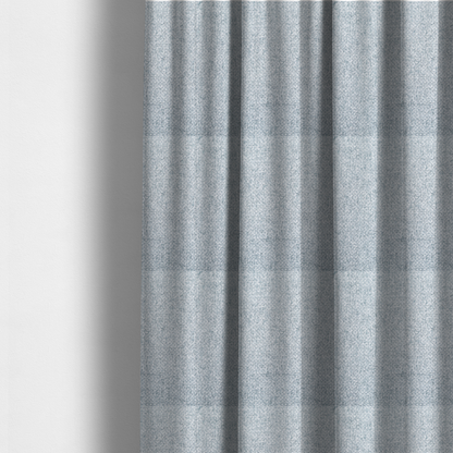 The fabric used to create these made-to-measure curtains is a tightly woven fabric in a soft, cool-toned sky blue and white blend, featuring a distinct, structured basket-weave pattern.