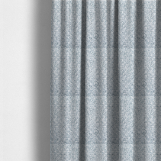 The fabric used to create these made-to-measure curtains is a tightly woven fabric in a soft, cool-toned sky blue and white blend, featuring a distinct, structured basket-weave pattern.