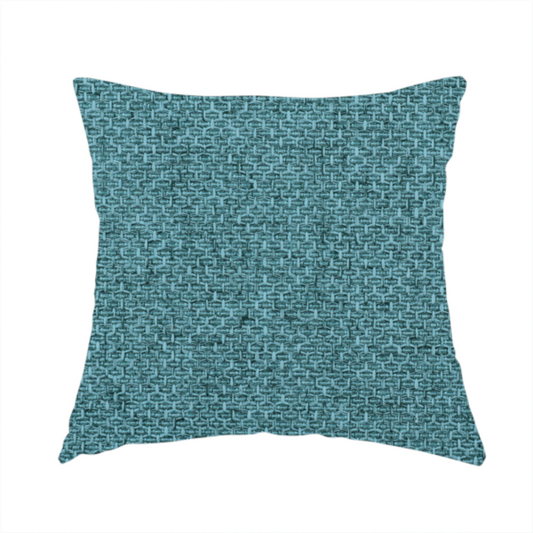 The fabric used to create this handmade cushion is a tightly woven fabric in a deep, cool-toned teal or seafoam blue, featuring a distinct, structured basket-weave pattern.
