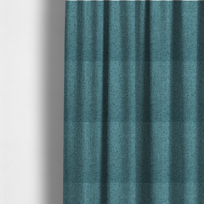 The fabric used to create these made-to-measure curtains is a tightly woven fabric in a deep, cool-toned teal or seafoam blue, featuring a distinct, structured basket-weave pattern.