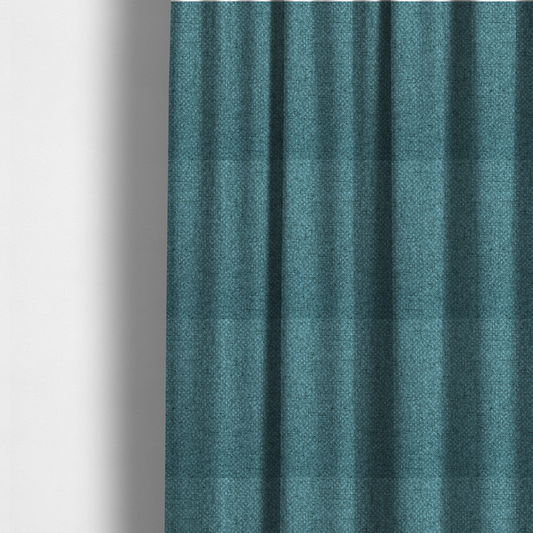 The fabric used to create these made-to-measure curtains is a tightly woven fabric in a deep, cool-toned teal or seafoam blue, featuring a distinct, structured basket-weave pattern.