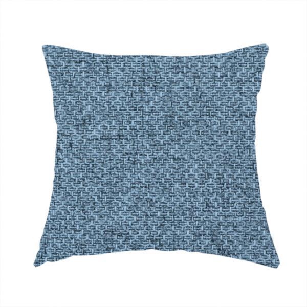 The fabric used to create this handmade cushion is a tightly woven fabric in a cool, muted slate blue, featuring a distinct, structured basket-weave pattern.