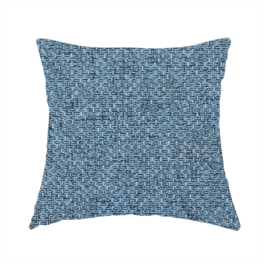 The fabric used to create this handmade cushion is a tightly woven fabric in a cool, muted slate blue, featuring a distinct, structured basket-weave pattern.