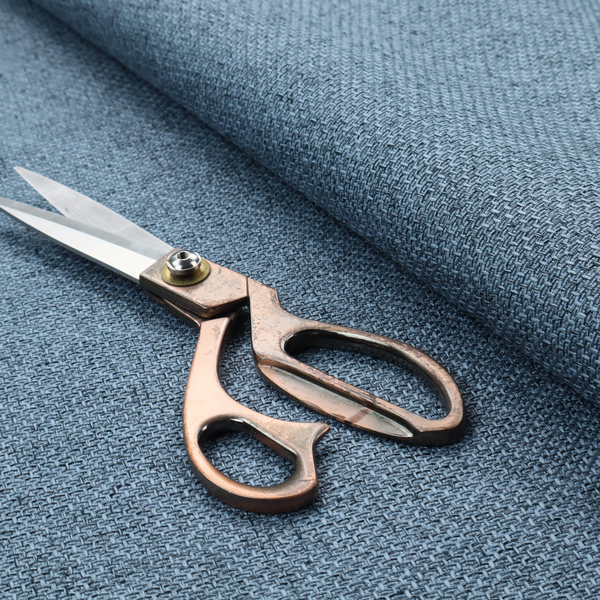 A tightly woven fabric in a cool, muted slate blue, featuring a distinct, structured basket-weave pattern.