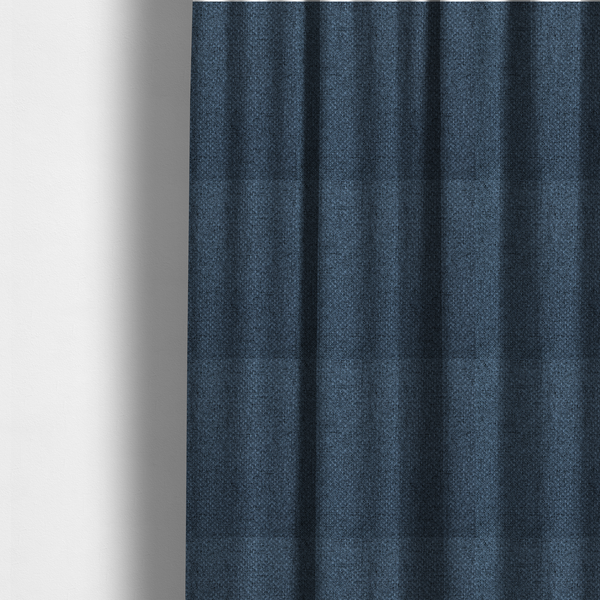 The fabric used to create these made-to-measure curtains is a tightly woven fabric in a deep, sophisticated navy blue, featuring a distinct, structured basket-weave pattern.
