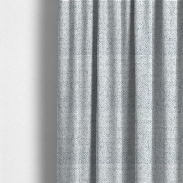 The fabric used to create these made-to-measure curtains is a tightly woven fabric in a bright, airy, and cool-toned silvery white, featuring a distinct, structured basket-weave pattern.