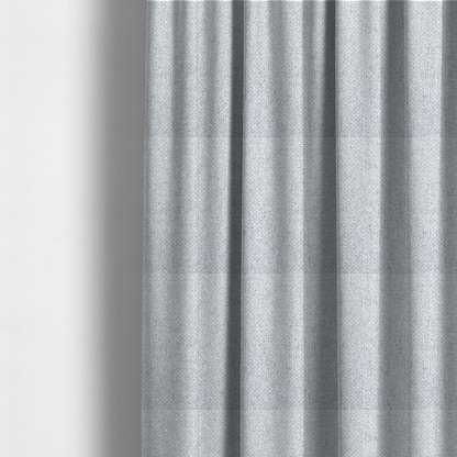 The fabric used to create these made-to-measure curtains is a tightly woven fabric in a bright, airy, and cool-toned silvery white, featuring a distinct, structured basket-weave pattern.