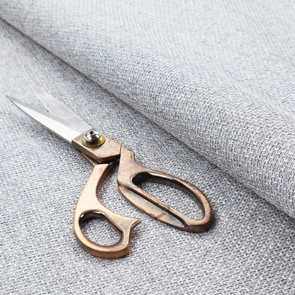 A tightly woven fabric featuring a blend of white and cool-toned grey threads, creating a soft, light heathered effect with a distinct, structured basket-weave pattern.