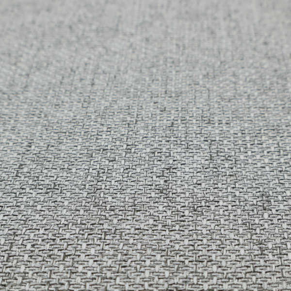 A tight, woven texture with a neutral, monochromatic colour palette. The surface consists of a blend of light grey, charcoal, and white yarns interlocked in a repeating, small-scale geometric pattern.