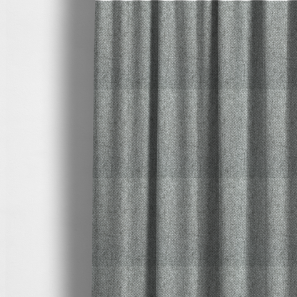 The fabric used to create these made-to-measure curtains is a tight, woven texture with a neutral, monochromatic colour palette. The surface consists of a blend of light grey, charcoal, and white yarns interlocked in a repeating, small-scale geometric pattern.