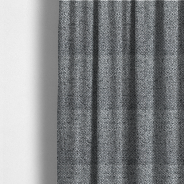 The fabric used to create these made-to-measure curtains is a durable, woven upholstery fabric featuring a monochromatic, heathered grey colour scheme. The weave is tight and consistent, characterized by an intricate, interlocking pattern of light, medium, and dark grey yarns that create a subtle, textured visual effect.