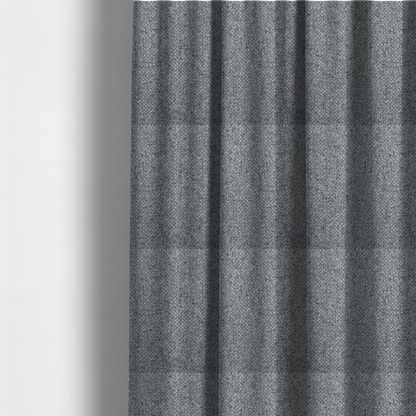 The fabric used to create these made-to-measure curtains is a durable, woven upholstery fabric featuring a monochromatic, heathered grey colour scheme. The weave is tight and consistent, characterized by an intricate, interlocking pattern of light, medium, and dark grey yarns that create a subtle, textured visual effect.