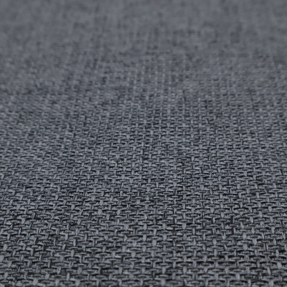 A sturdy, woven upholstery fabric in a deep, sophisticated charcoal grey. Like the previous samples, it features a tight, consistent weave with an interlocking geometric pattern.