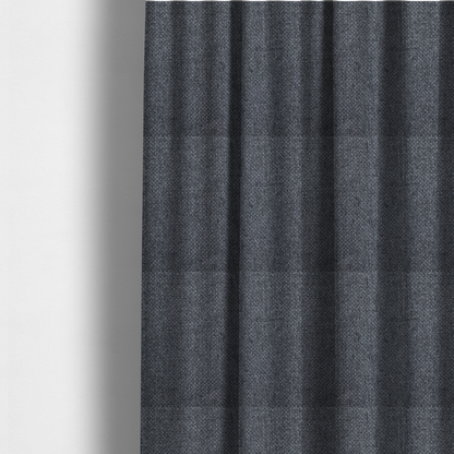 The fabric used to create these made-to-measure curtains is a  sturdy, woven upholstery fabric in a deep, sophisticated charcoal grey. Like the previous samples, it features a tight, consistent weave with an interlocking geometric pattern.
